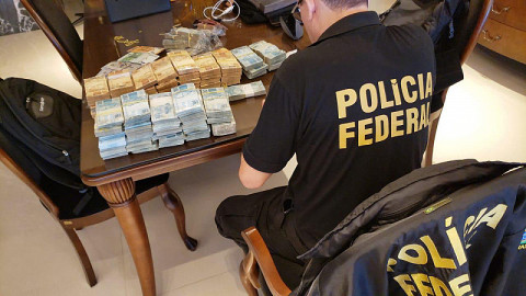 Agente da PF separa dinheiro apreendido em operação de hoje (Imagem: Divulgação)